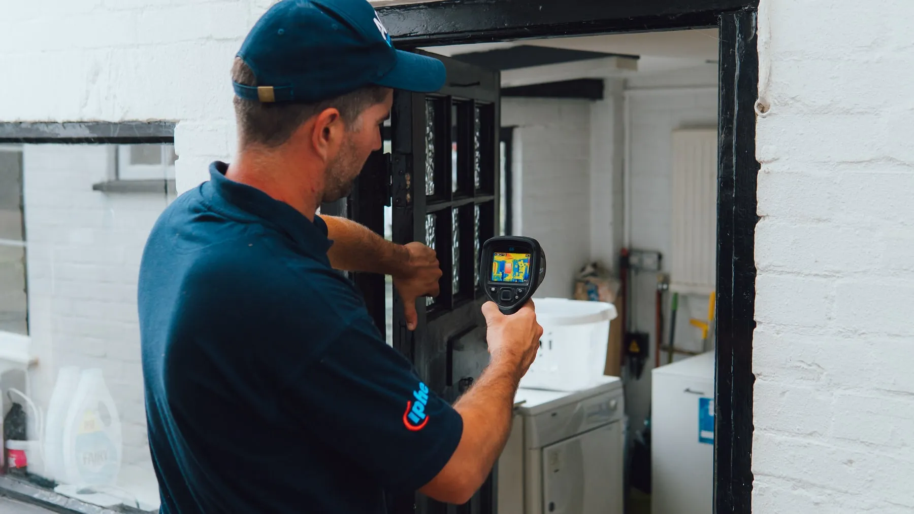 ADI engineer using a thermal camera to investigate pipework in a home